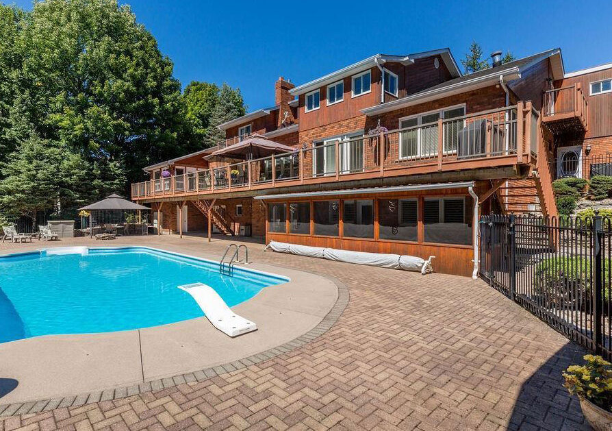 14 Trillium Trail - Backyard showing large upper deck and saltwater pool with diving board